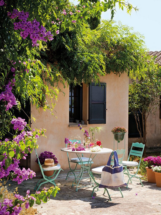 Mediterranean yard with bistro table and bougainvillea via El Mueble