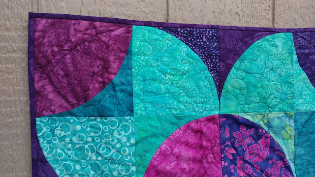 Fizzy block modern quilt using purple and teal Island Batik fabrics