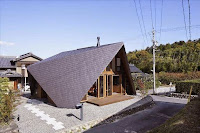 Origami House Design with A-Frame in an Old Village Surrounded by Mountains