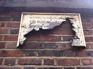 Battered, car parking sign in Shoreditch, London EC2