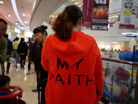 woman wearing a "MY FAITH" sweatshirt