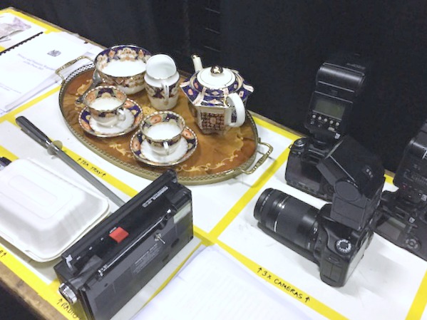 Family Activities in Nottingham | Morgan's Milieu: A table of props sits behind the stage, labelled, waiting for the actors to pick them up.