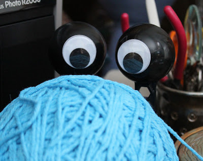 googly eyes hiding behind yarn