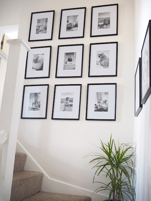 Nine frame gallery wall on stairs and landing