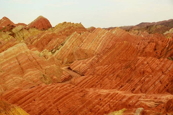 These incredible landscapes look as if they have been painted in the sweeping pastel brush strokes of an impressionistic artwork. But in fact these remarkable pictures show the actual scenery of Danxia Landform at Nantaizi village of Nijiaying town, in Linzhe county of Zhangye, Gansu province of China. Formed of layers of reddish sandstone, the terrain has over time been eroded into a series of mountains surrounded by curvaceous cliffs and unusual rock formations.