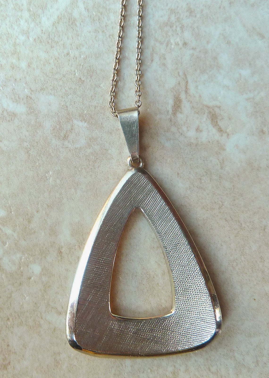 http://www.kcavintagegems.uk/vintage-modernist-style-sterling-silver-triangle-pendant-and-chain-335-p.asp