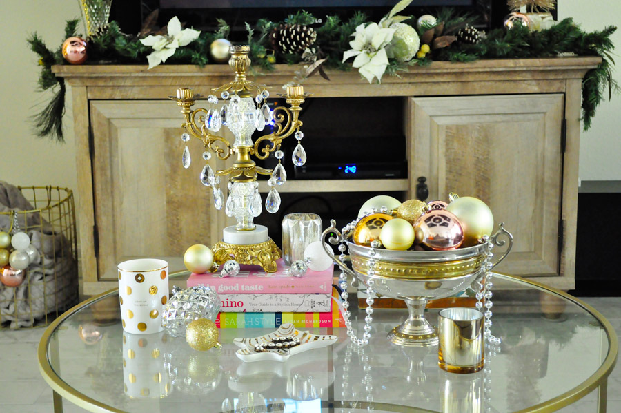 Vintage candle holder is the star of this coffee table decor vignette with blush, silver, gold and white accents.