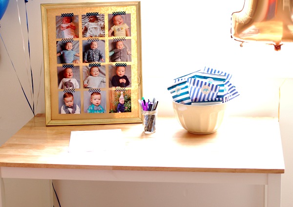 Monthly baby photo collage sits on a party table.