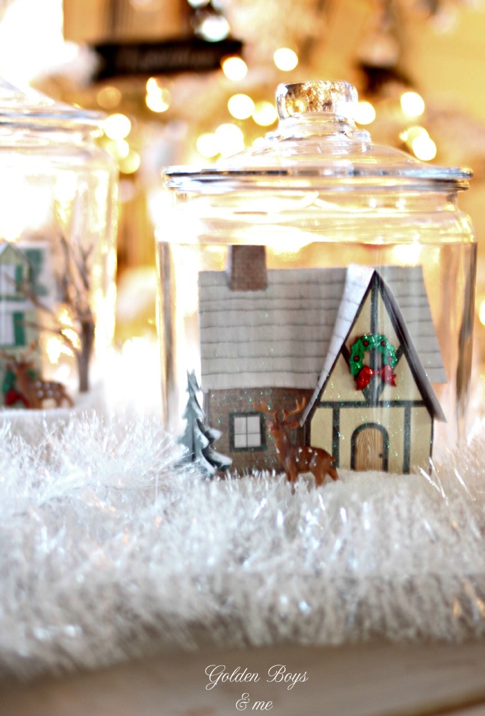 Winter village made of paper and glitter in glass cookie jars with salt as snow - www.goldenboysandme.com