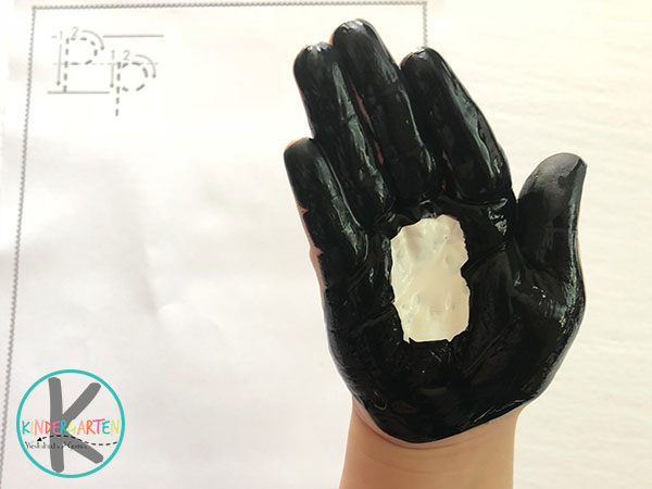 next paint black around the white palm next paint black around the white palm