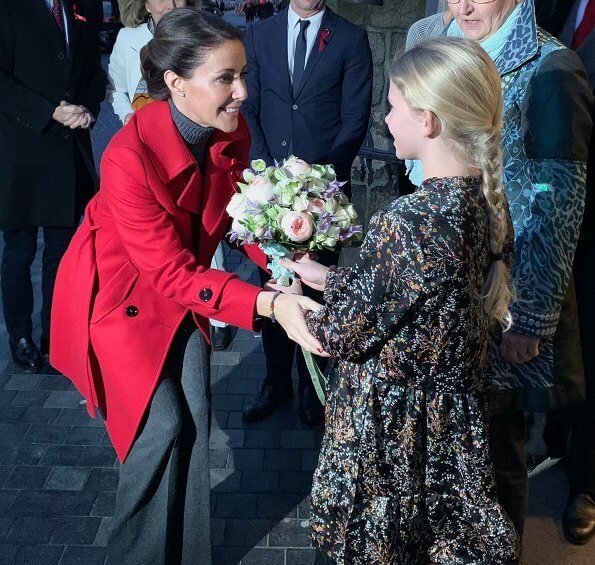 The Danish AIDS Foundation at Trinitatis Church in Copenhagen. candle lighting event, She wore a red wool coat by Maje