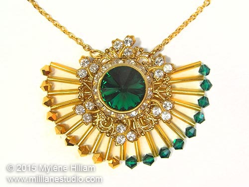 Art deco inspired sunray pendant featuring Aurum and Emerald Swarovski Crystals and long gold bugle beads