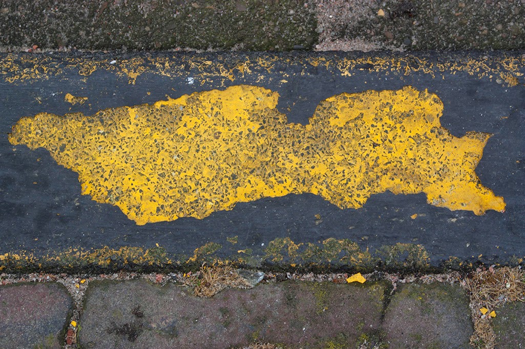 chipped yellow street curb