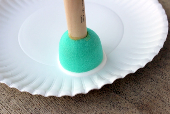 Put the paint on a paper plate and then get the paint on your circle sponge. 