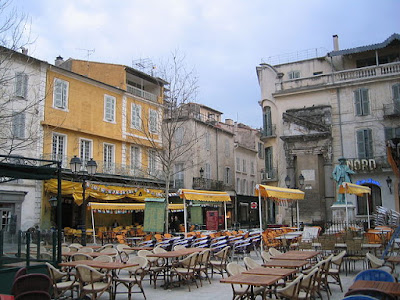 "Arles-PlaceDuForum". Licensed under Public Domain via Wikimedia Commons - http://commons.wikimedia.org/wiki/File:Arles-PlaceDuForum.jpg#/media/File:Arles-PlaceDuForum.jpg
