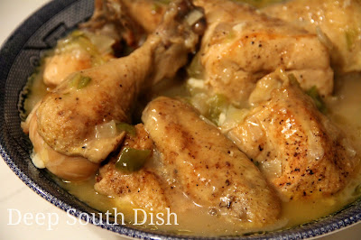 This traditional stewed chicken dish begins with a browned, cut up chicken, that is slow cooked in a roux based gravy.