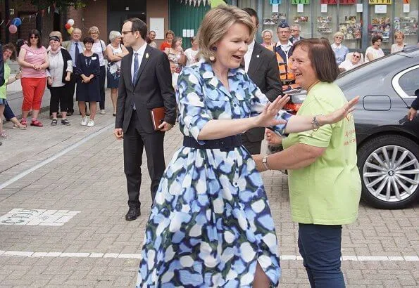 Queen Mathilde visits Playground Space summer camp in Zoutleeuw. The Queen wore Natan blue print midi shift dress