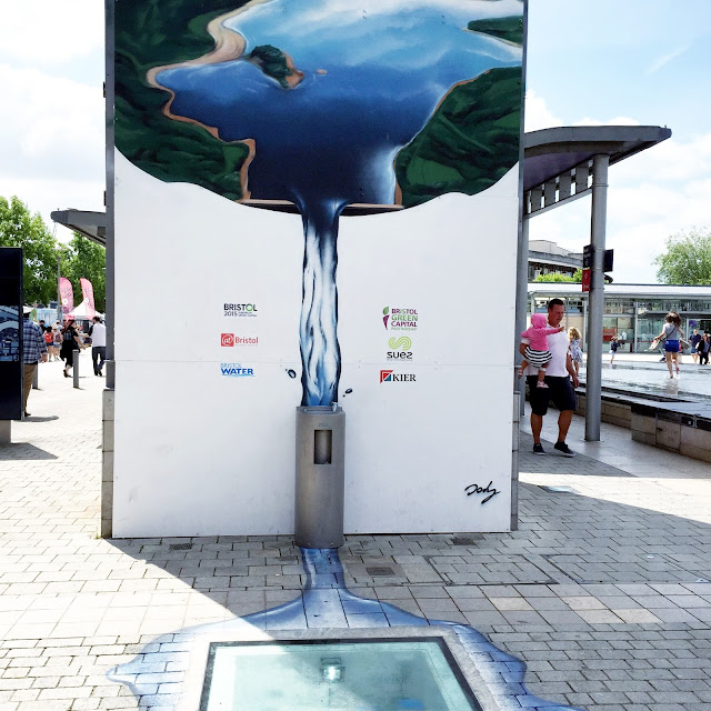 Water fountain with street art in Millennium Square