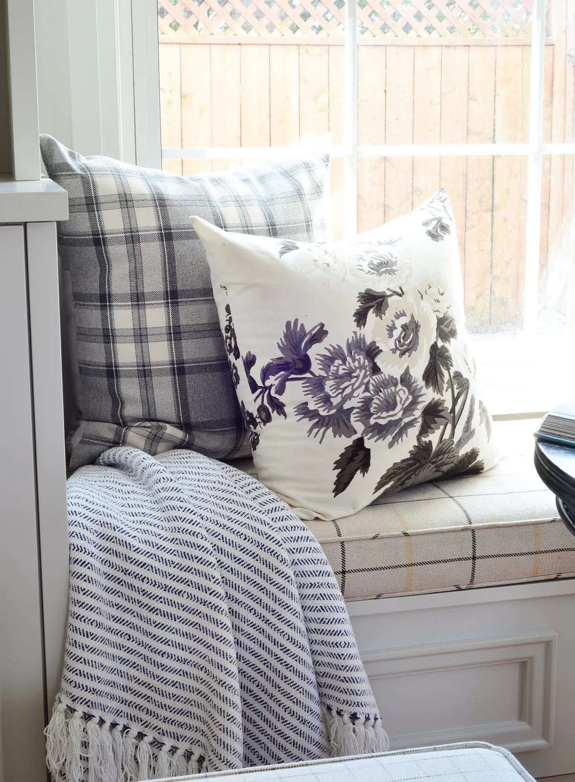 cozy window bench seat, floral pillow cover, striped throw, plaid cushion covers