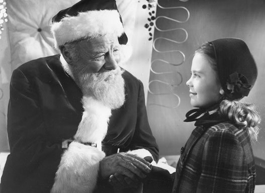 Kris holds Susan's hand in Miracle on 34th Street