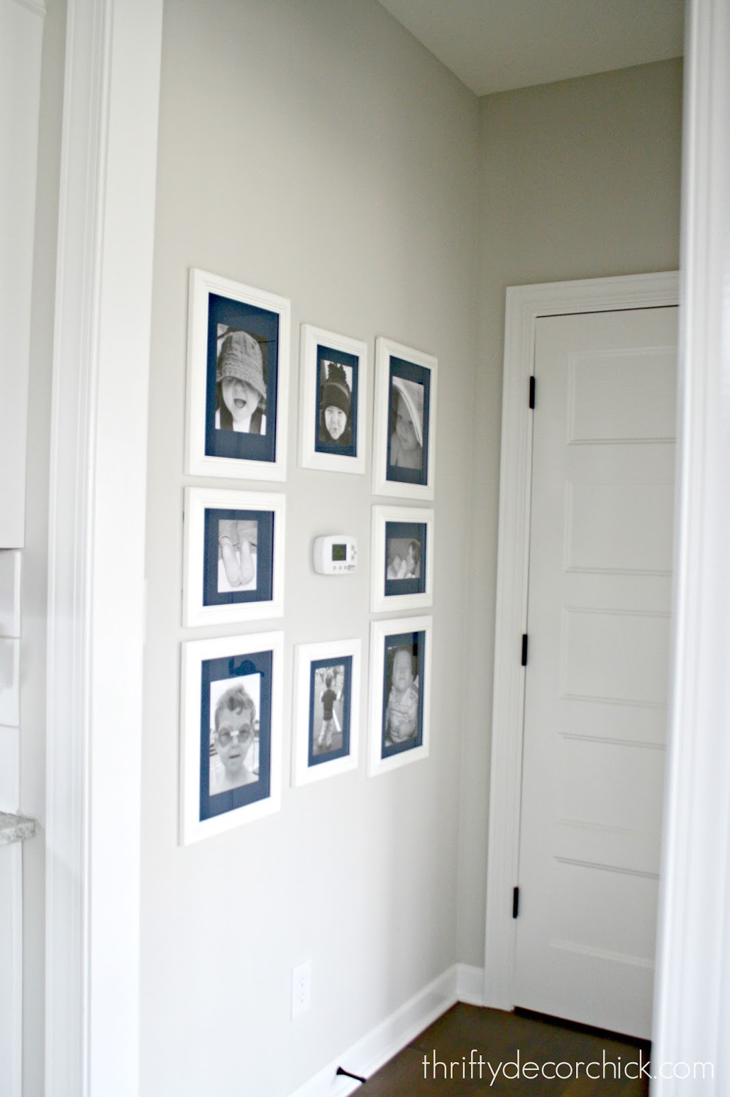 Art wall around the thermostat (and a hanging art hack) from Thrifty
