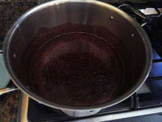 Blackberry and Sugar in a stainless steel pot.