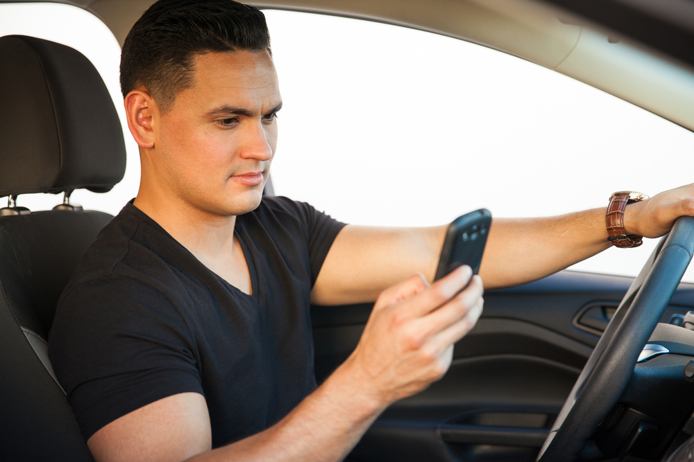 Does he drive a car. He can Drive a car. Мужчина в машине за рулем селфи. Texting while looking at man. Person texting.