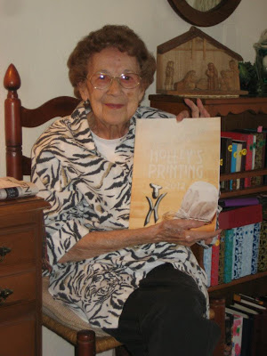 Older woman holding a planner with recipes inside