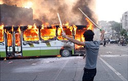 Protester burns a bus
