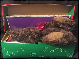 Fitting large stuffed animal into an Operation Christmas Child shoebox.
