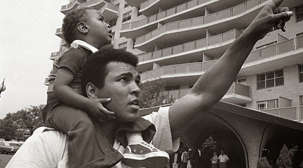 Muhammad Ali holds his son in 1974 in The Trials of Muhammad Ali.