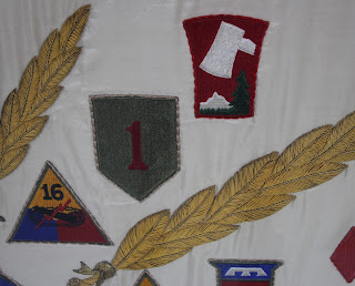 Closeup of stitching technique used to apply unit patches to Patton's Third Army flag - a presentation piece given to the General in 1945. Historic flag preservation, conservation, repair, framing and mounting, textile conservator, Spicer Art Conservation, George Patton Museum of Leadership