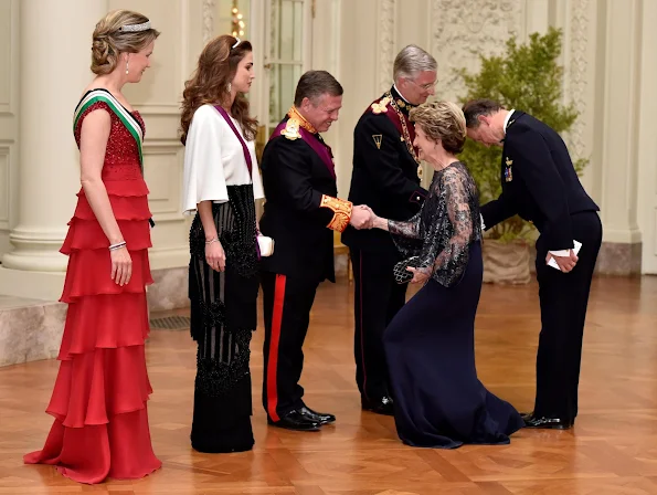 Queen Mathilde and Queen Rania attends a gala dinner at the Laeken royal Palace in Brussels. Queen Rania wore Valentino Gown, Queen Mathilde wore red gown. Queen Mathilde wore diamondTiara, Queen Rania diamond tiara
