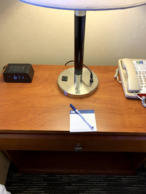 a desk with a telephone and a lamp on it