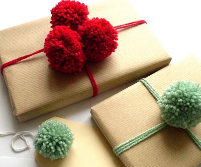 Leftover yarn to tie a gift box and gorgeous pom poms as accents