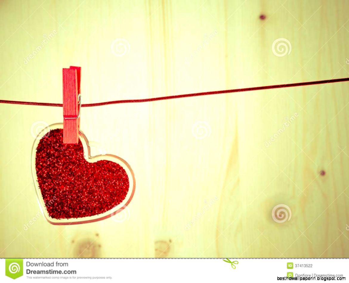Vintage Decorative Red Heart Hanging On Wood Background Concept