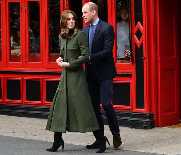 Kate Middleton wore a green midi dress by Suzannah. Alexander McQueen khaki long coat and Jimmy Choo boots