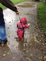 Toddler splashing in puddles
