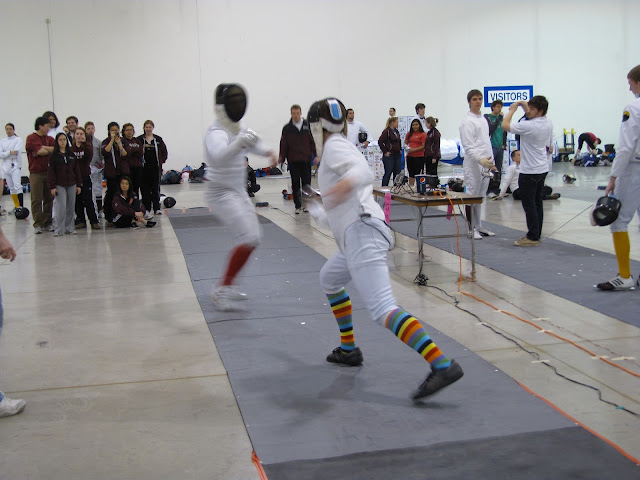 A fencing match in action
