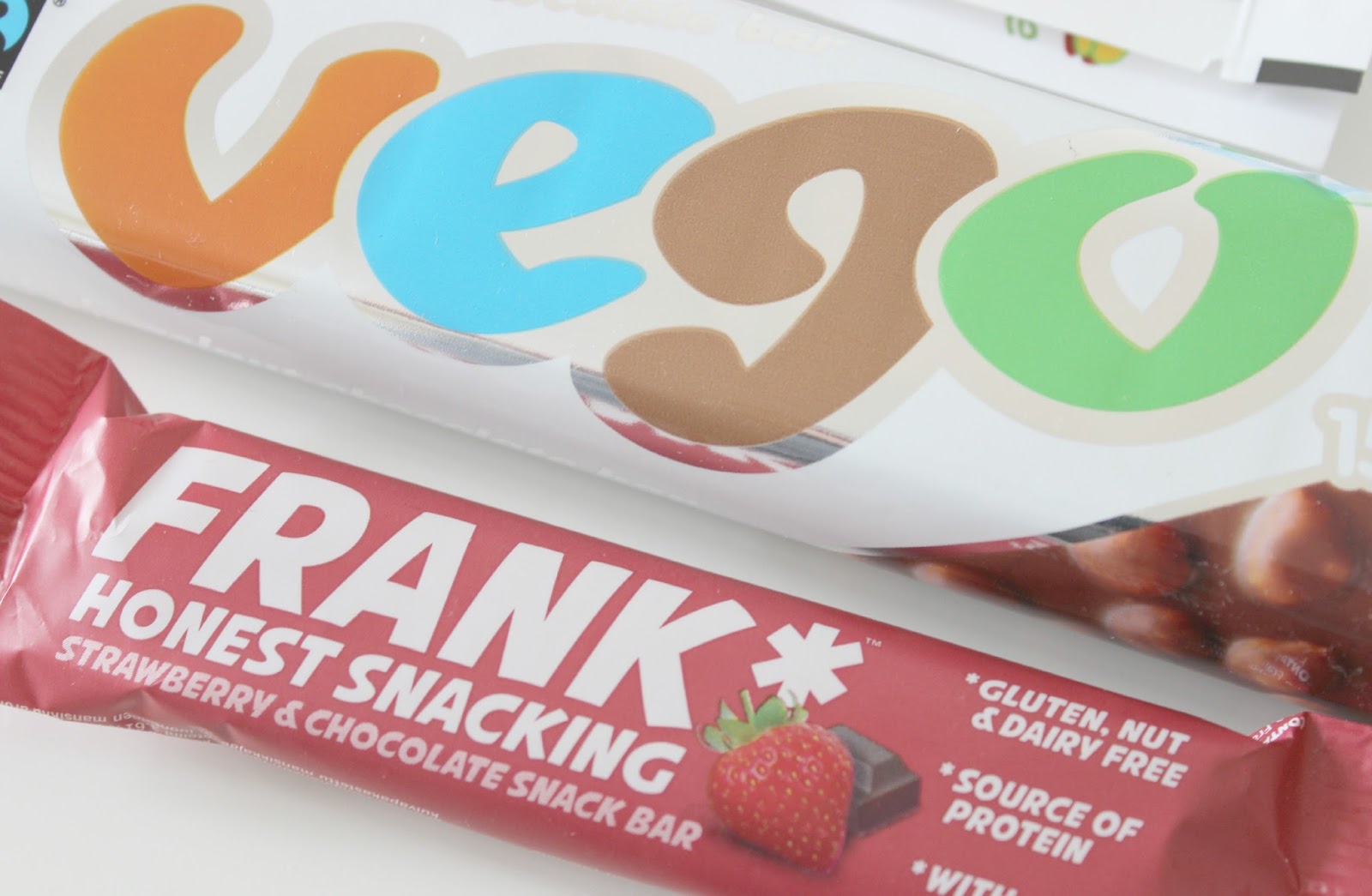 A picture of FRANK Honest Snacking Strawberry & Chocolate Snack Bar and Vego Whole Hazelnut Chocolate Bar
