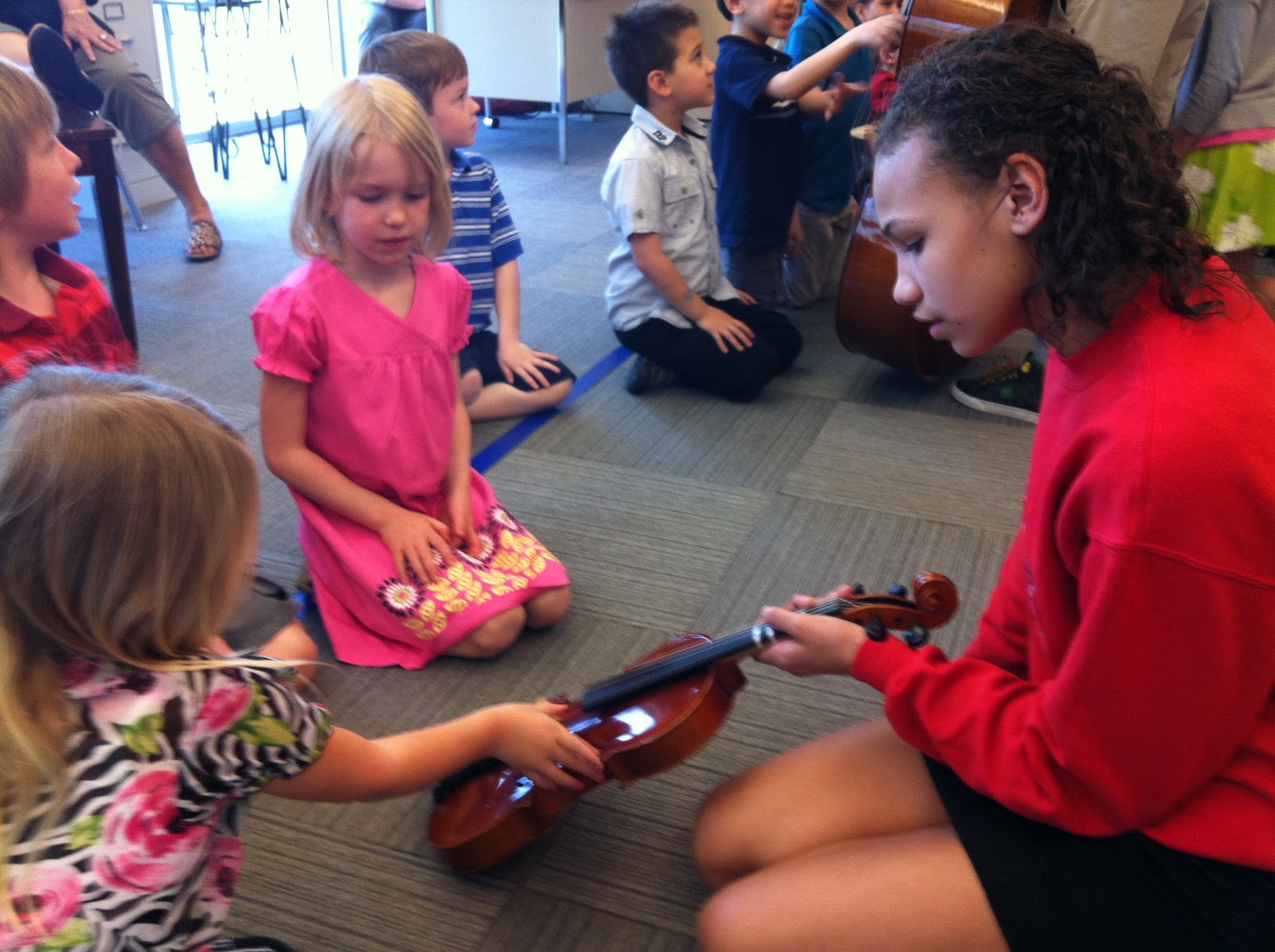 Mrs. Hannah's First Grade Class: 6th grade orchestra play for 1st grade