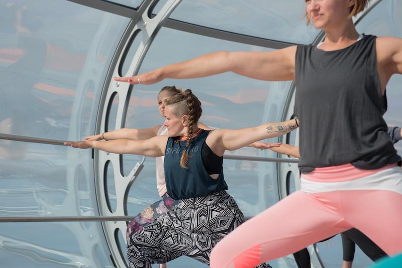 Yoga in the sky on the i360 with MyEscape and Nine Lives Yoga - Tess Agnew fitness blogger doing Warrior pose