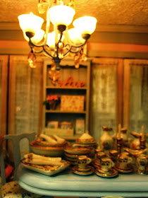 Close-up view of a modern miniature shabby chic shop, showing a dining table displaying a dinner set.