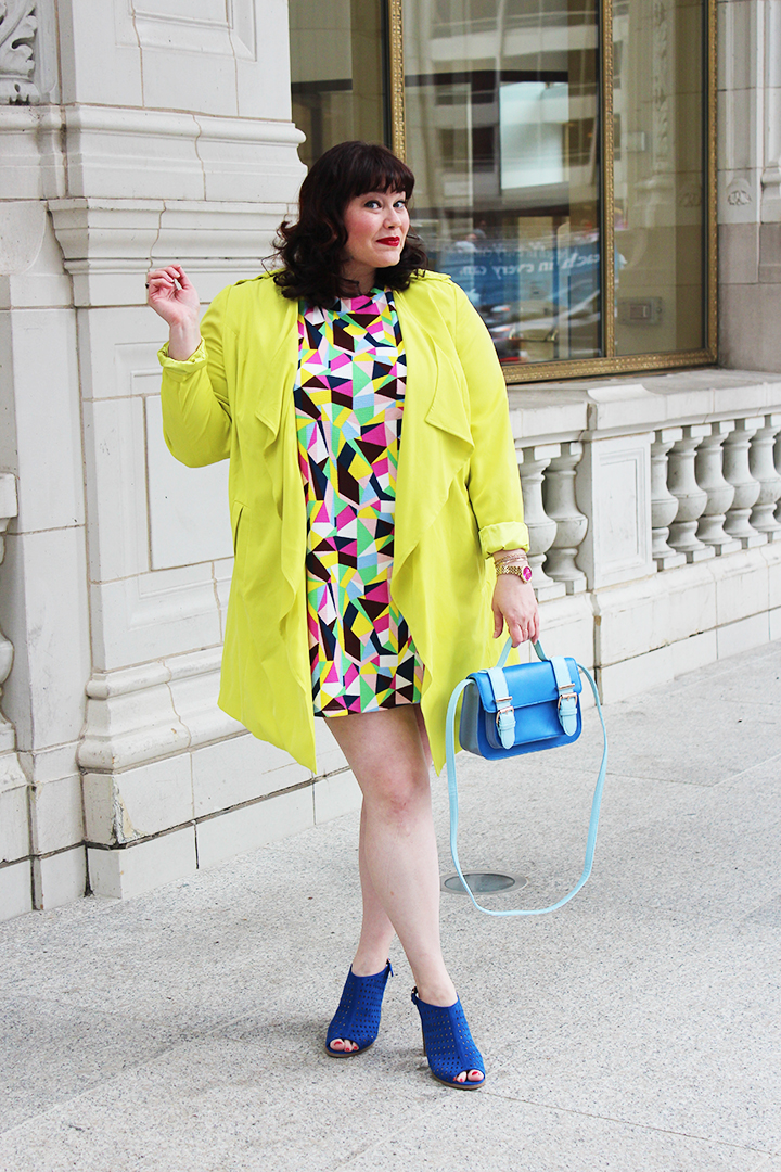 Plus Size Blogger Amber from Style Plus Curves in a Simply Be USA Colorful Abstract Dress, Bright Yellow Coat and Blue Accessories