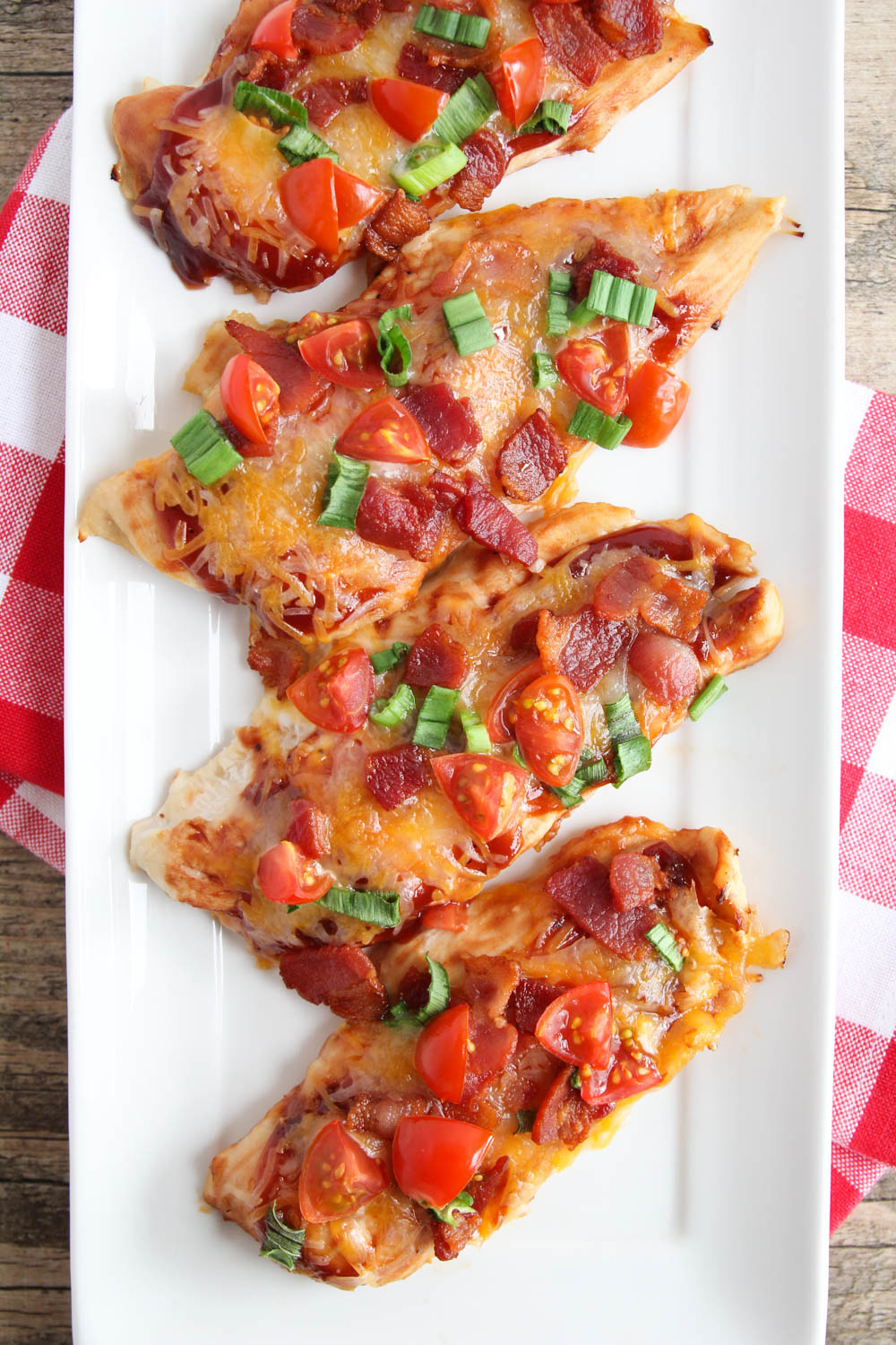 This flavorful Monterey chicken is smothered in barbecue sauce, gooey cheese, fresh green onions and tomatoes, and crispy bacon. An easy and delicious main dish the whole family will love!