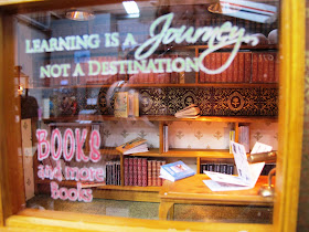 View through the window into a one-twelfth scale book shop.