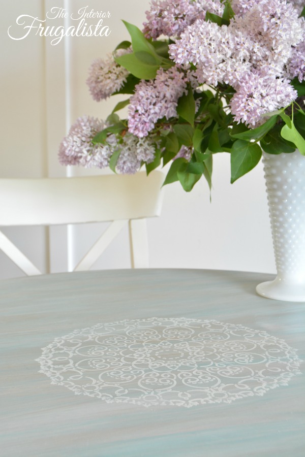 Round dining table with stenciled doily top