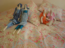 Lukretzias and Gizike bunnies sitting on a huge quilt