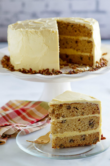 This lovely cake is the perfect combination of flavors and textures. The warm maple syrup blends perfectly with pecans for an out of this world cake, the maple frosting is amazing too! Dessert is served and it's delicious! cake with slice missing