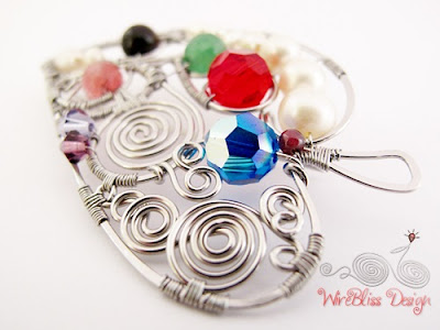 Wire wrapped leaf brooch with multi colored gemstones